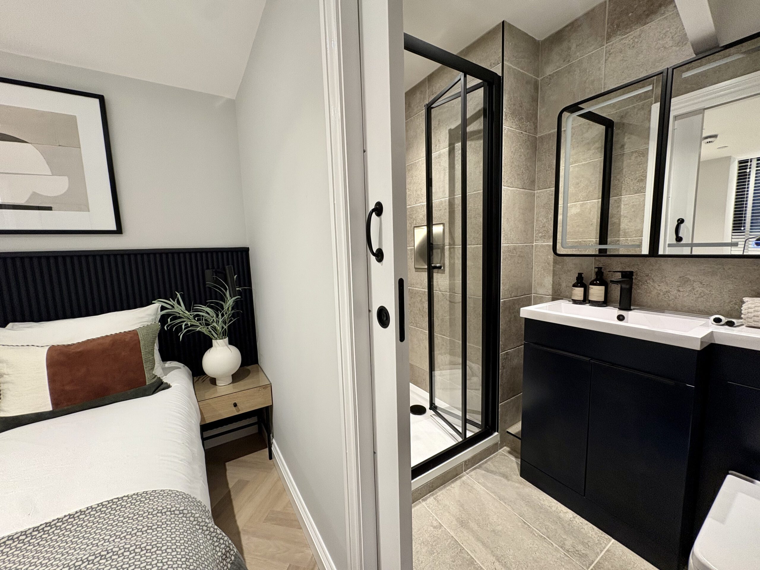 A cosy bedroom with an en suite and toilet, emphasising functionality and privacy